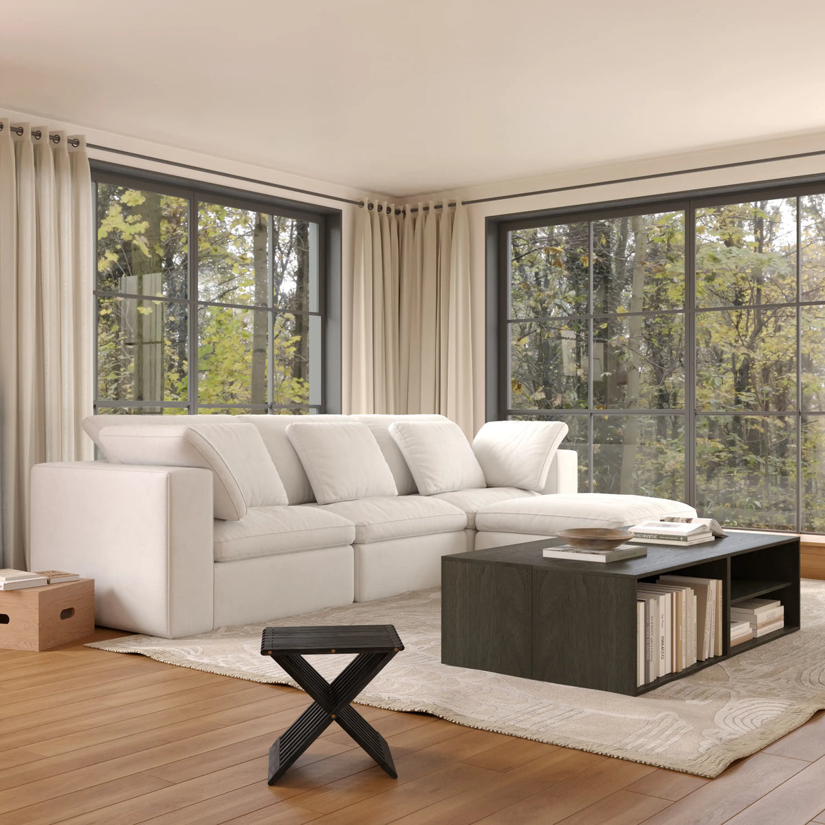 The modern and simple open living room is furnished with a white modular four-seater L-shaped sofa and a coffee table consisting of black modular basic cabinets.