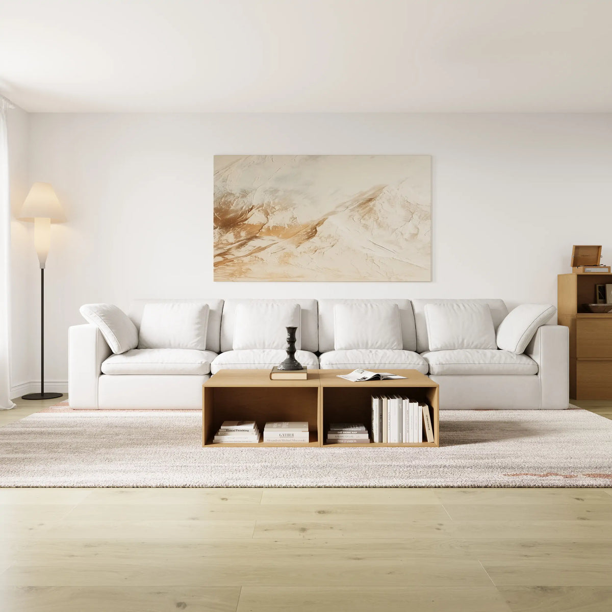 The modern and simple living room is furnished with a modular 4-seater sofa and a modular log-colored coffee table and chest of drawers.