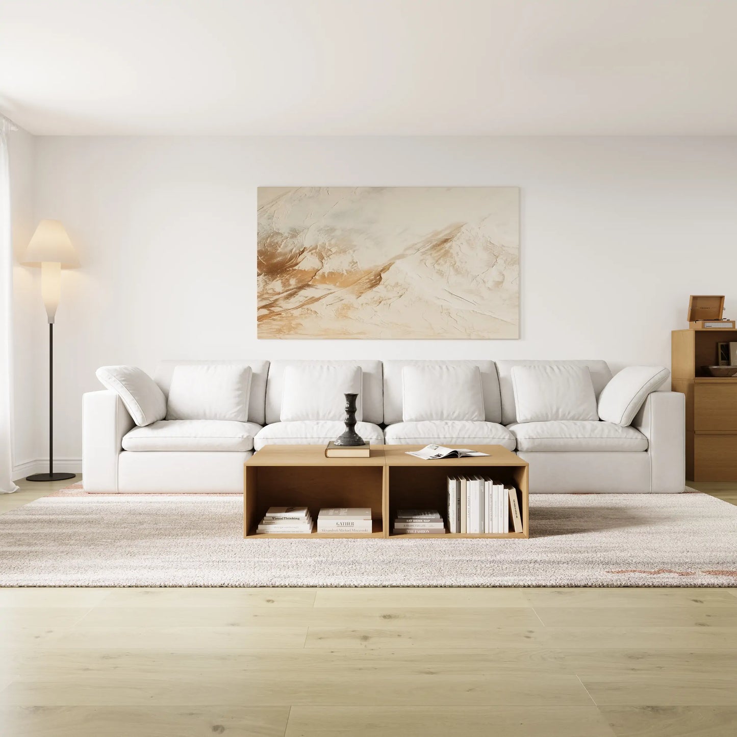 The modern and simple living room is furnished with a modular 4-seater sofa and a modular log-colored coffee table and chest of drawers.